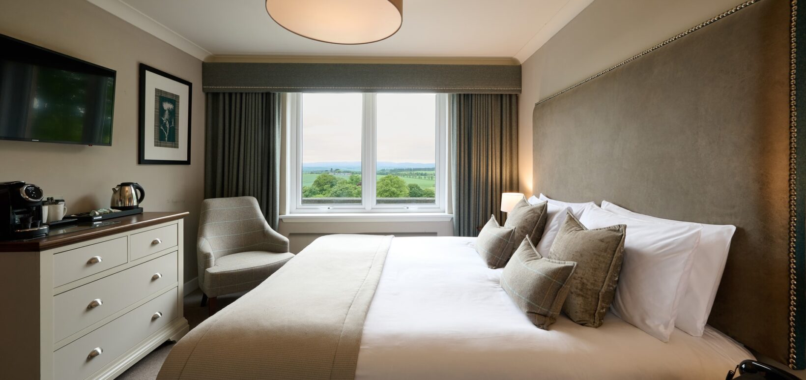 King sized bed with views over the countryside